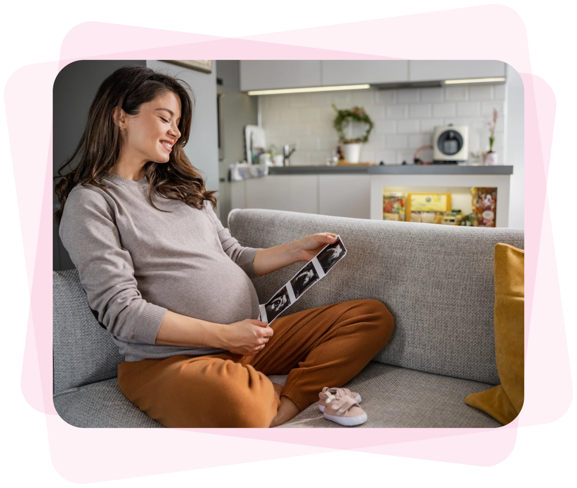 A woman sitting on the couch holding her phone.